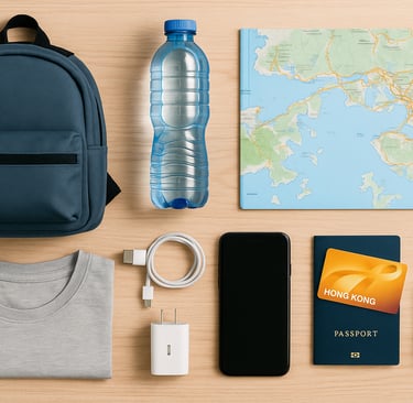 Flat lay of essential items for budget travel in Hong Kong, including a backpack, folded t-shirt, water bottle, Hong Kong map