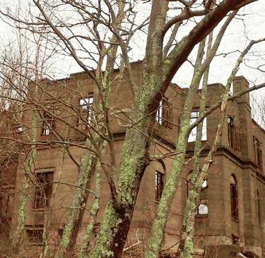 Crumbled concrete ruins of an abandoned hotel hidden deep in a foggy forest near Woodstock, New York, with vines and moss gro