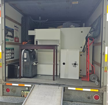 a truck with a refrigerator and cabinets in the back of it