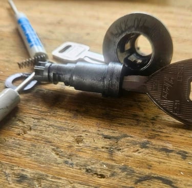 1994 Ford Escort ignition on a table being repaired representing locksmith ignition service in Fletcher, NC