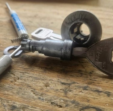 Car ignition repair service by Jack’s Locksmith in Burnsville NC showing ignition cylinder and key during repair.