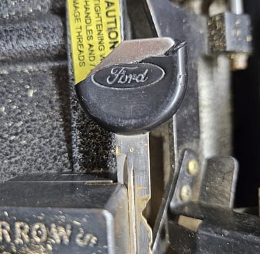 Close-up of a worn Ford car key fob for replacement or duplication