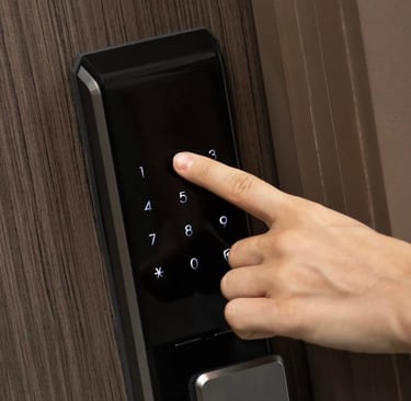 A hand touching a digital lock representing Jack’s Locksmith high security lock services in Marshall, NC