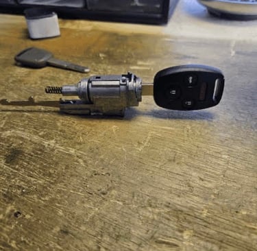 Car key fob and ignition cylinder on a workbench