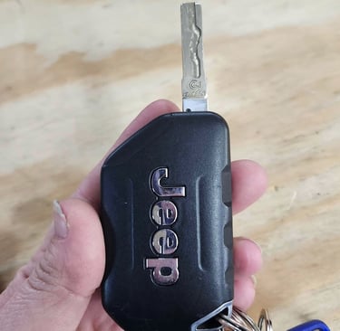 Holding jeep key fob representing auto locksmith services in Boone.