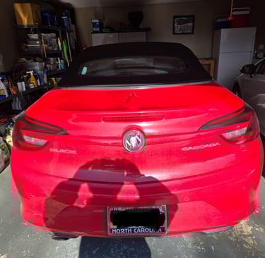 Red Buick Cascada parked in garage