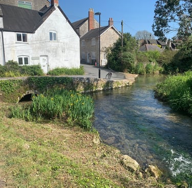 Looking downstream on the River Wey towards the corner of Mill Street  Upwey
