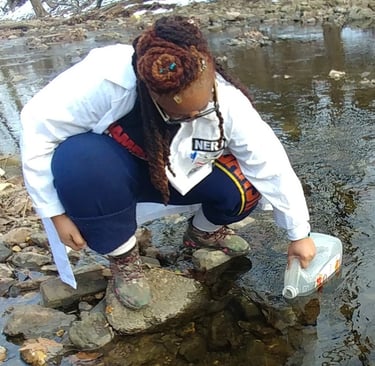 Shenell is collecting water samples for an environmental assessment