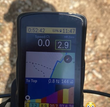 a gps device mounted to a bike showing uphill climbing