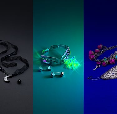 Flat-lay Halloween jewelry: onyx choker, chrome earrings, antique choker with emerald on textured backdrop