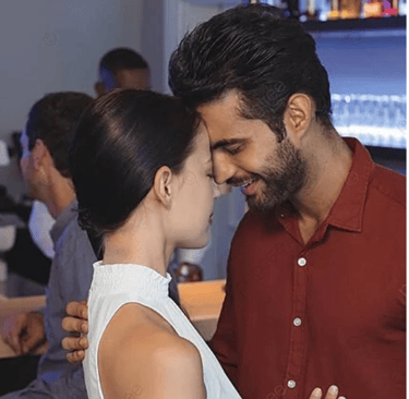 a man and woman in a bar with a man kissing Martin PE / COACH