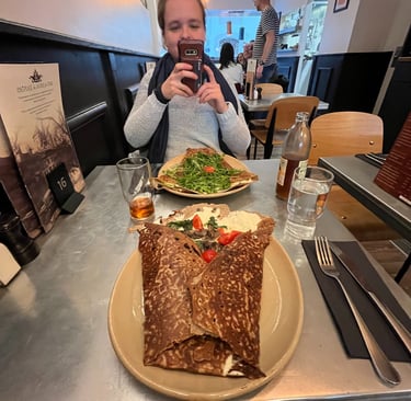 Corinne from Hidden Switzerland Travel taking a photo of a crepe at Creperie du Bourg-de-Four
