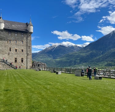 The Courtyard of Schloss Leuk with the town hall in the foreground and the Alps in the backgroudn