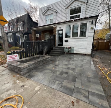 interlock driveway with stone planter and stone steps