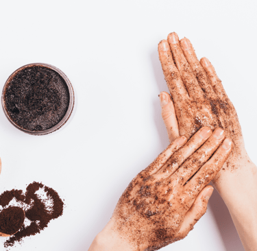Coffee scrub applied on hands at Kayuh Spa