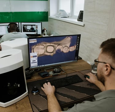 a man sitting at a desk with a computer monitor and a computer monitor 3d designing