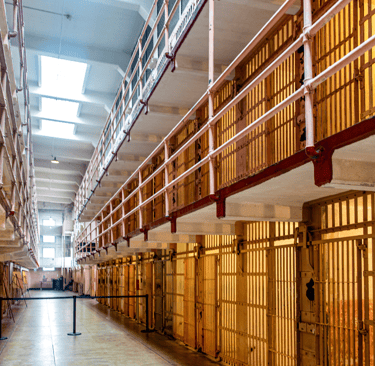 a long prison hallway with a long row of prison bars with bars and bars