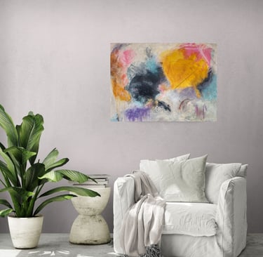 yellow and black painting above lounge chair