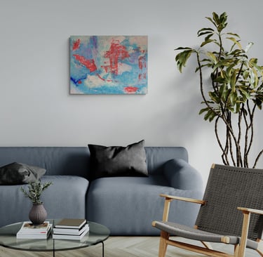 Blue and red artwork on wall above grey sofa.