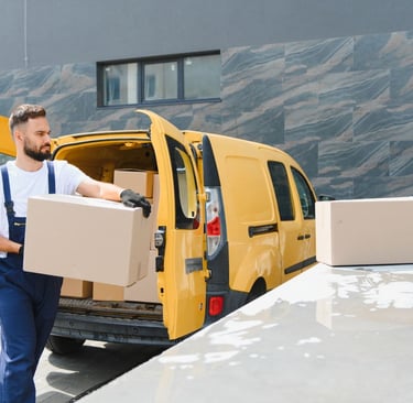 Man carrying box from yellow van