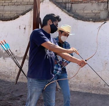 horsearchery instructor teaching archery to a young student