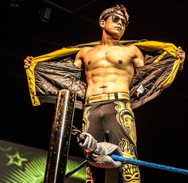 Jake De Leon standing on a turnbuckle in a wrestling ring