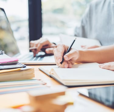man and woman studying and writing