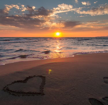 sunset at a beach overlooking a sea
