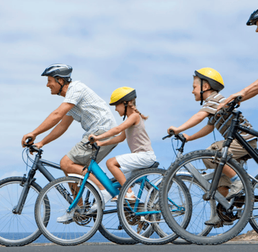 A family of three cycling in the outdoors.