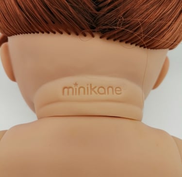Minikane stamp on the back of a dolls neck