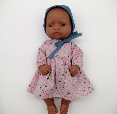 Small Miniland doll in handmade pink dress and denim bonnet