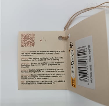 Tag with warnings for Minikane doll Augustine