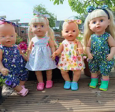 Baby Born and Big Sister dolls dressed in summer outfits