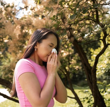 Side view of woman blowing her nose