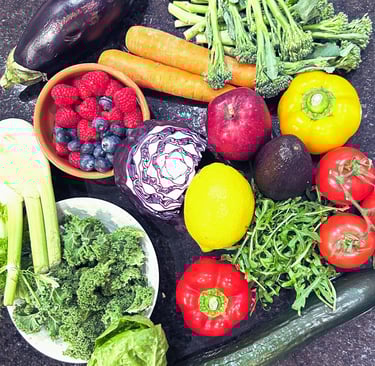 Variety of vegetables and fruits e.g. berries, kale, tomatoes, carrots, peppers, broccoli, lemon