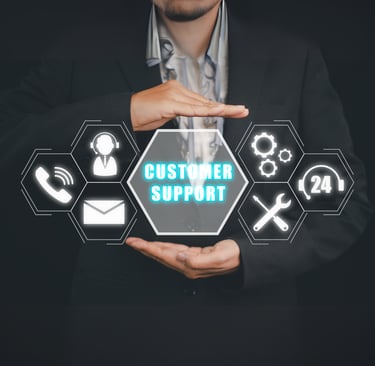 Businessman holding a glowing "Customer Support" icon with phone, email, and 24/7 service icons.
