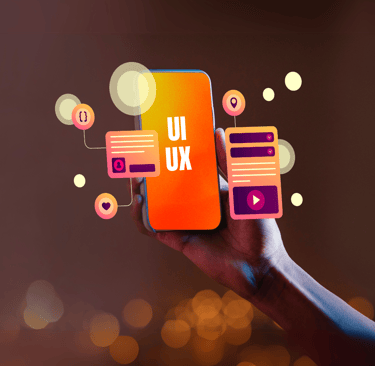 Hand holding a smartphone displaying "UI UX" with floating design elements and icons around it.
