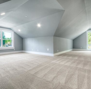 Freshly vacuumed carpeted attic space with natural light – SparkEaseCleaning 