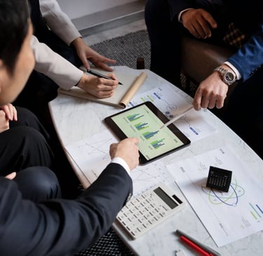 three persons discussing data on table