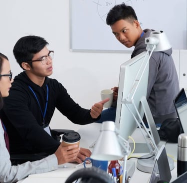 three persons with a computer screen