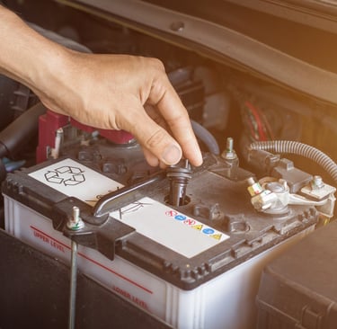 a person is holding a battery in their hand