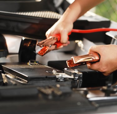 a person is holding a battery and a jump up in the air