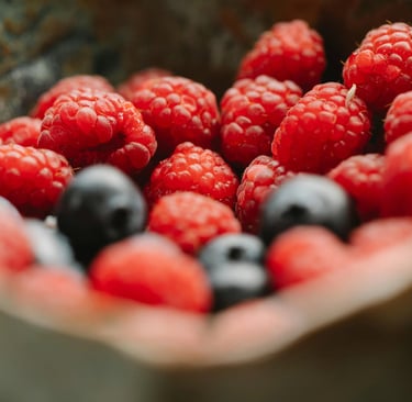 a bowl of raspberries and berries in a bowl