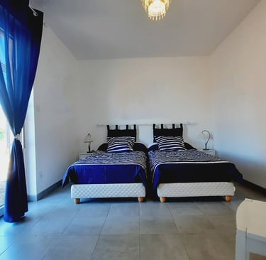 a bedroom with two beds and a table