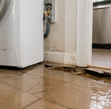Water leaking from a washing machine causing floor damage