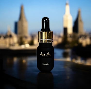 a bottle of perfume on a table with a city in the background