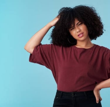 a woman with a curly afro hairs and a red shirt