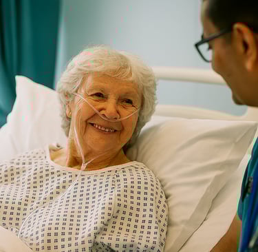a heartwarming moment between an elderly woman on oxygen and a caring doctor