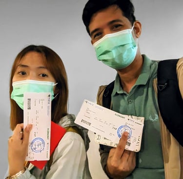 A couple wearing facemasks and holding tickets