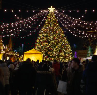 Slow living journal scene of people gathered outdoors under festive lights